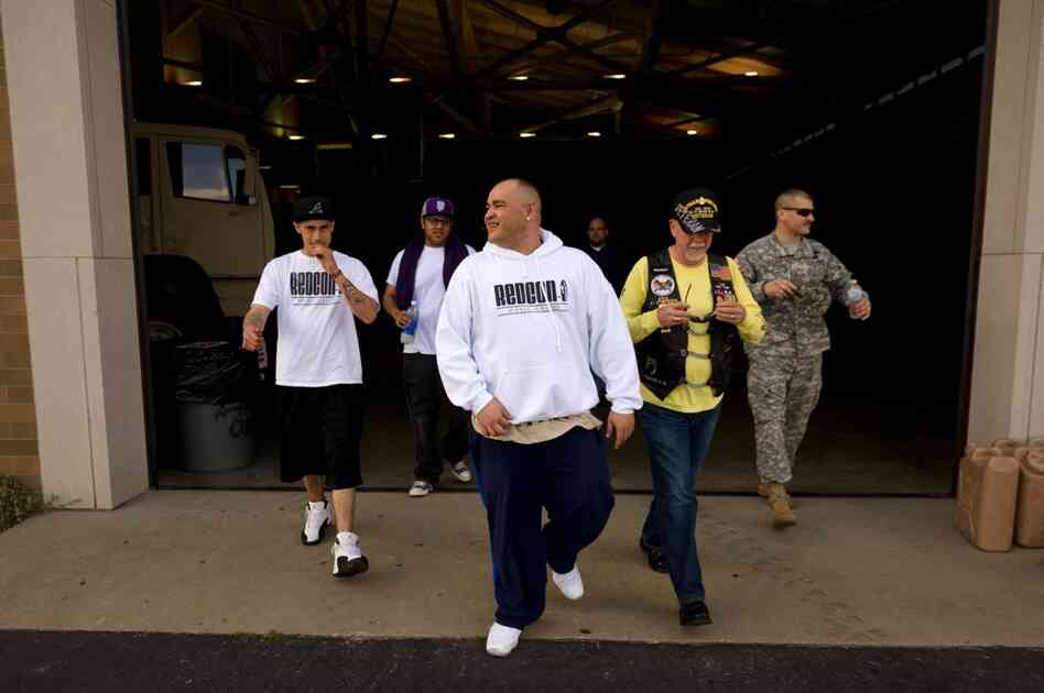 Barillaro (center) leaves the armory after a sound check for his evening hip-hop performance. The 35-year-old comes from a military family; he says he has wanted to be a soldier since he was 12 years old. While in Iraq, he led convoys for the Army.