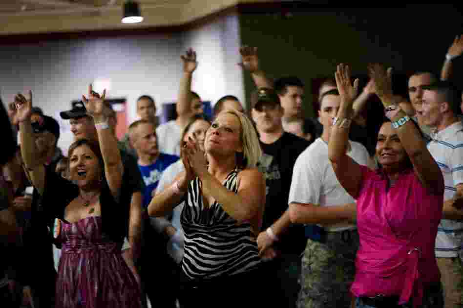 Misty Grayson of Evansville, Ind. (center), claps as Barillaro performs.