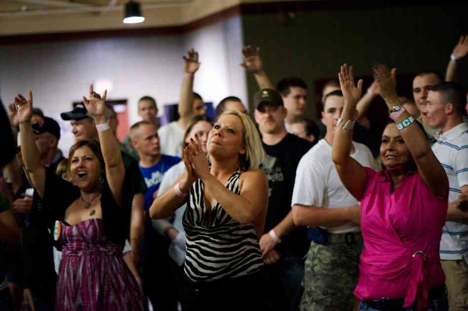 Misty Grayson of Evansville, Ind. (center), claps as Barillaro performs.