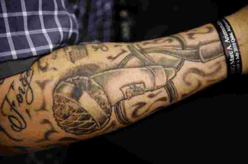 Barillaro's arm is tattooed with a microphone.