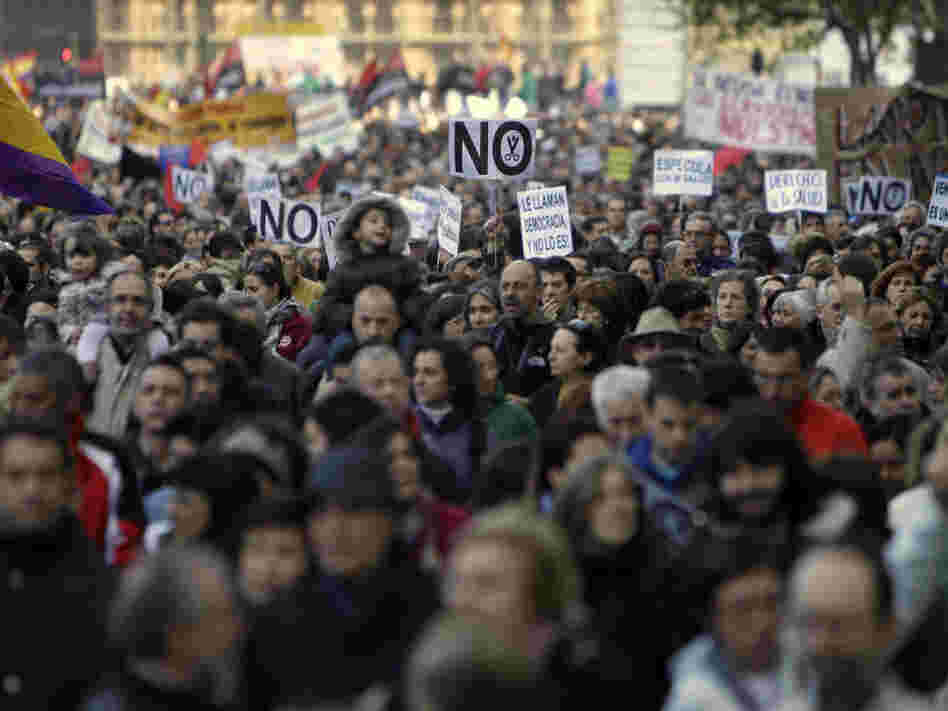 People march during a demonstration against health and education cuts recently announced by the Spanish government, in Madrid on Sunday.