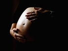 A pregnant woman holds her stomach June 7, 2006 in Sydney, Australia. A pregnant woman holds her stomach June 7, 2006 in Sydney, Australia.