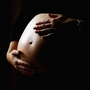 A pregnant woman holds her stomach June 7, 2006 in Sydney, Australia.