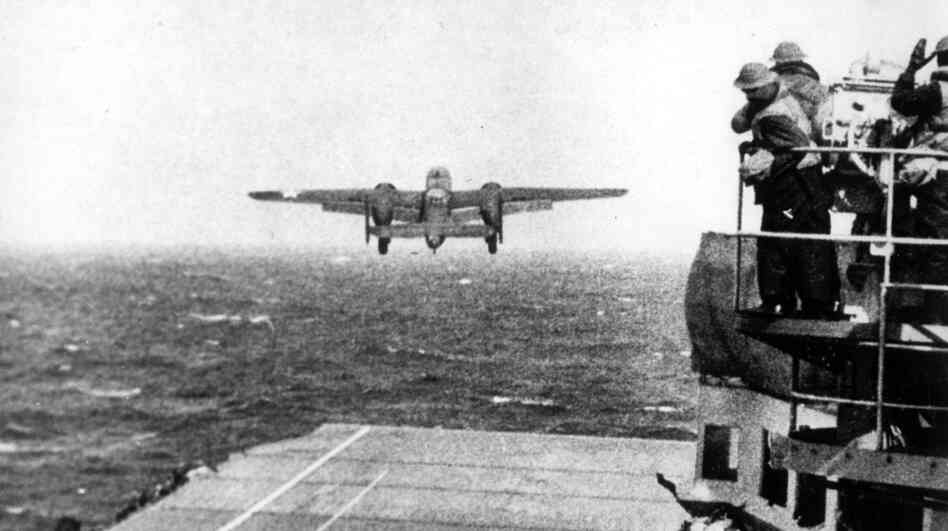 U.S. Navy crewmen watch a B-25 bomber take off from the USS Hornet for the Doolittle Raid on Tokyo on April 18, 1942. U.S. Navy crewmen watch a B-25 bomber take off from the USS Hornet for the Doolittle Raid on Tokyo on April 18, 1942.