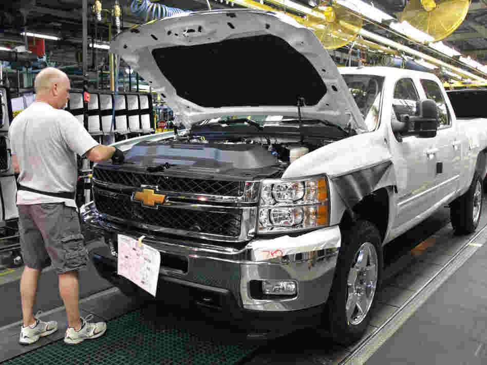 A worker assembles a Silverado truck on the assembly line at the GM Flint Assembly plant in Michigan.