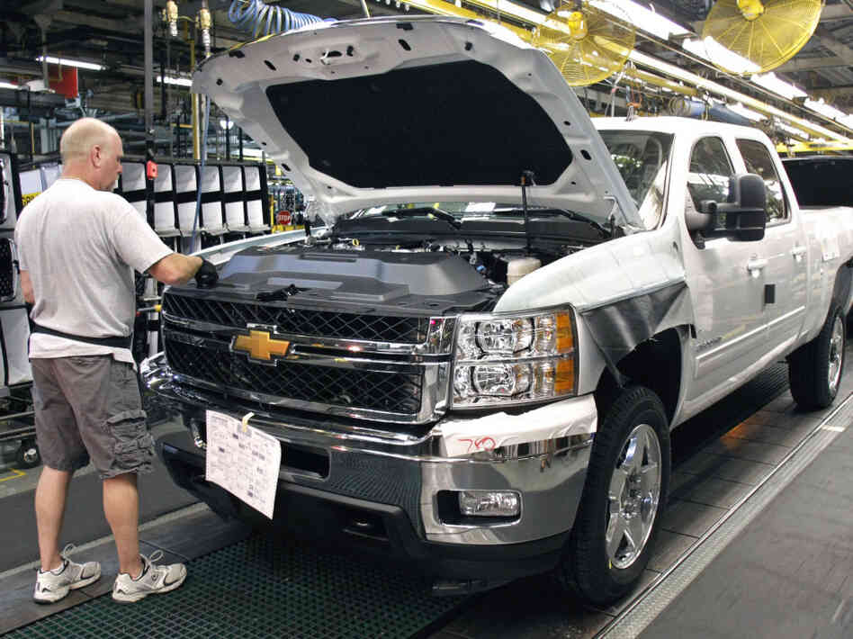 A worker assembles a Silverado truck on the assembly line at the GM Flint Assembly plant in Michigan.