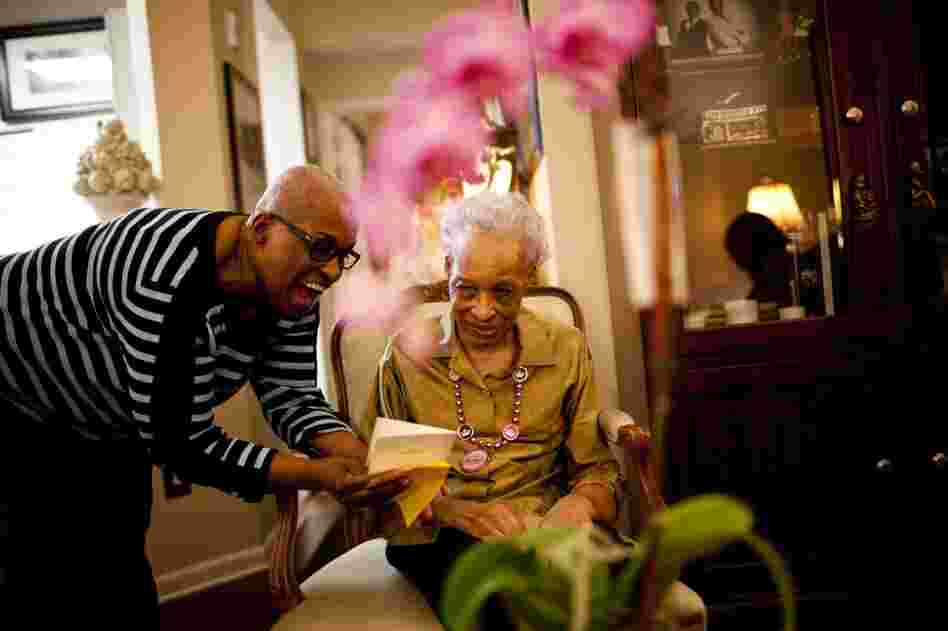 Geneva reads a card for her mother during Ida's 89th birthday party.