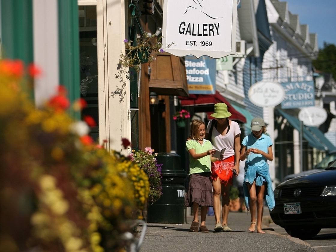 Tourists walk near shops in the Maine seaside village of Northeast Harbor.