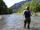 KUOW reporter Ashley Ahearn wades into the Elwha River.