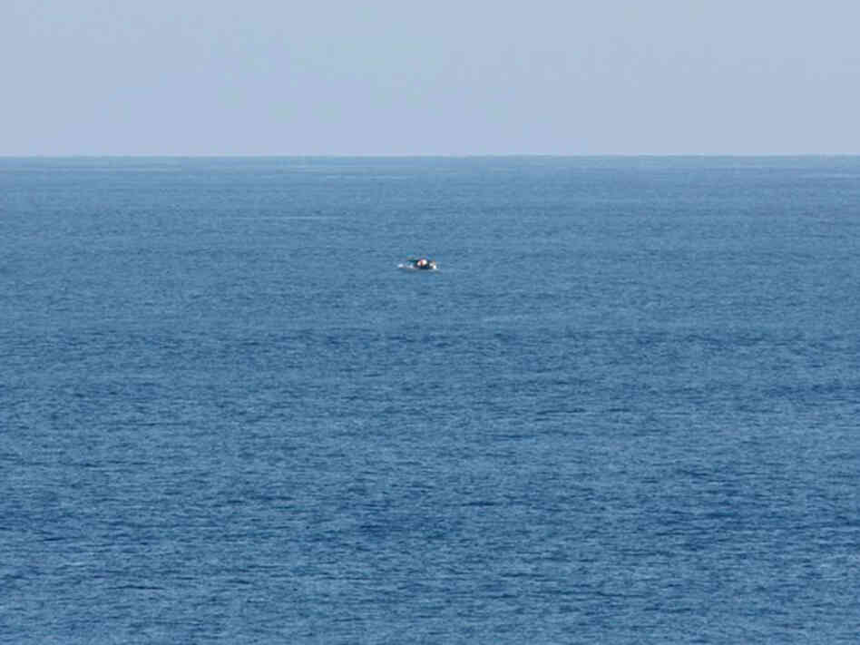 Bird-watcher Jeff Gilligan snapped this photograph of a small boat in distress. Gilligan and others say the cruise ship he was traveling on did not stop to help the stricken craft.