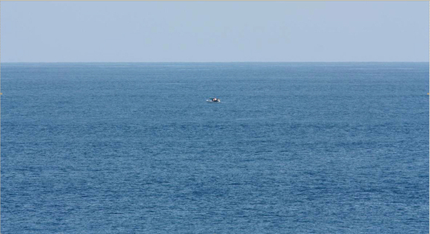 Bird-watcher Jeff Gilligan snapped this photograph of a small boat in distress. Gilligan and others say the cruise ship he was traveling on did not stop to help the stricken craft.