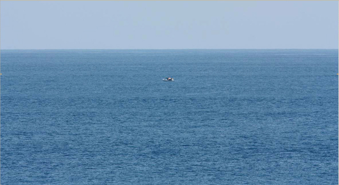 Bird-watcher Jeff Gilligan snapped this photograph of a small boat in distress. Gilligan and others say the cruise ship he was traveling on did not stop to help the stricken craft.