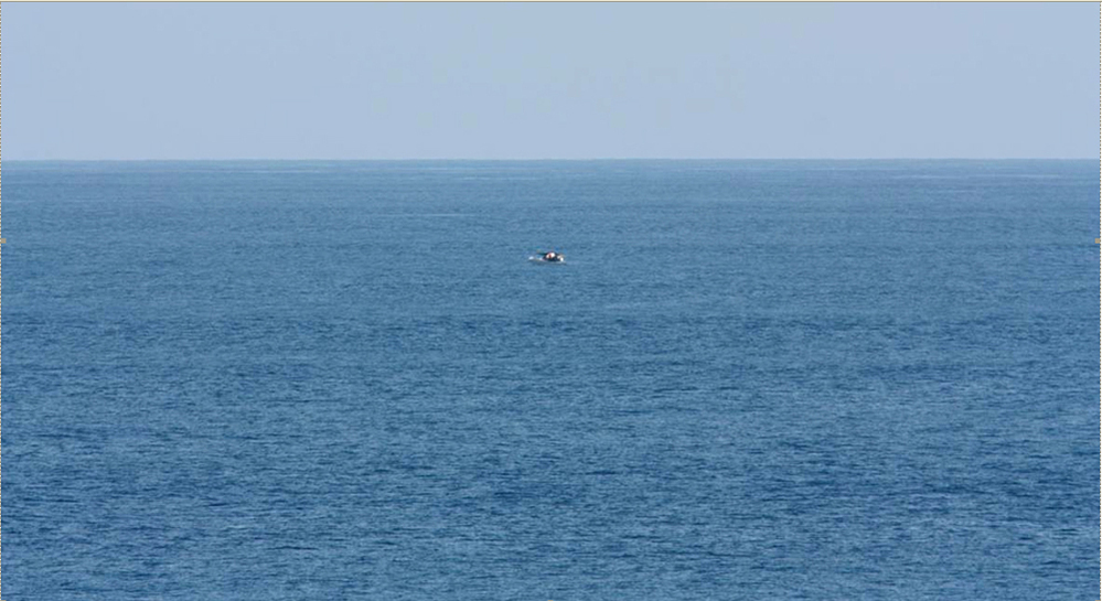 Bird-watcher Jeff Gilligan snapped this photograph of a small boat in distress. Gilligan and others say the cruise ship he was traveling on did not stop to help the stricken craft.