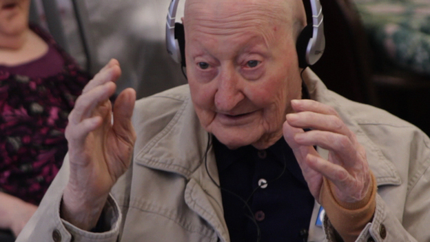 Joe, a nursing home resident, broke into song during a personalized music session. His story and others are documented in the film Alive Inside.