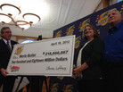 Merle and Patricia Butler (at right) accepting their ceremonial check earlier today. Merle and Patricia Butler (at right) accepting their ceremonial check earlier today.