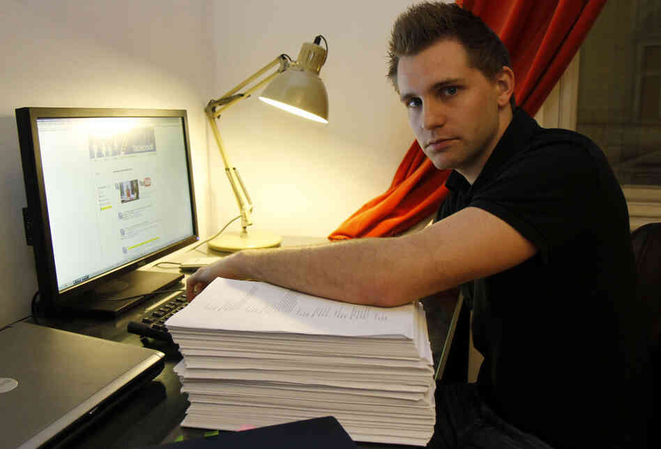 Many Web users have little idea about how, or when, they're being tracked. In this 2011 photo, Max Schrems of Austria sits with 1,222 pages about his activities on Facebook — the company gave him the file after he requested it under European law.