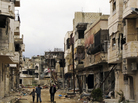 Syrians walk through a badly damaged neighborhood in the central city of Homs on Sunday. Despite a declared cease-fire, fighting has continued in a number of Syrian cities, and peace efforts are at risk of collapsing. Syrians walk through a badly damaged neighborhood in the central city of Homs on Sunday. Despite a declared cease-fire, fighting has continued in a number of Syrian cities, and peace efforts are at risk of collapsing.