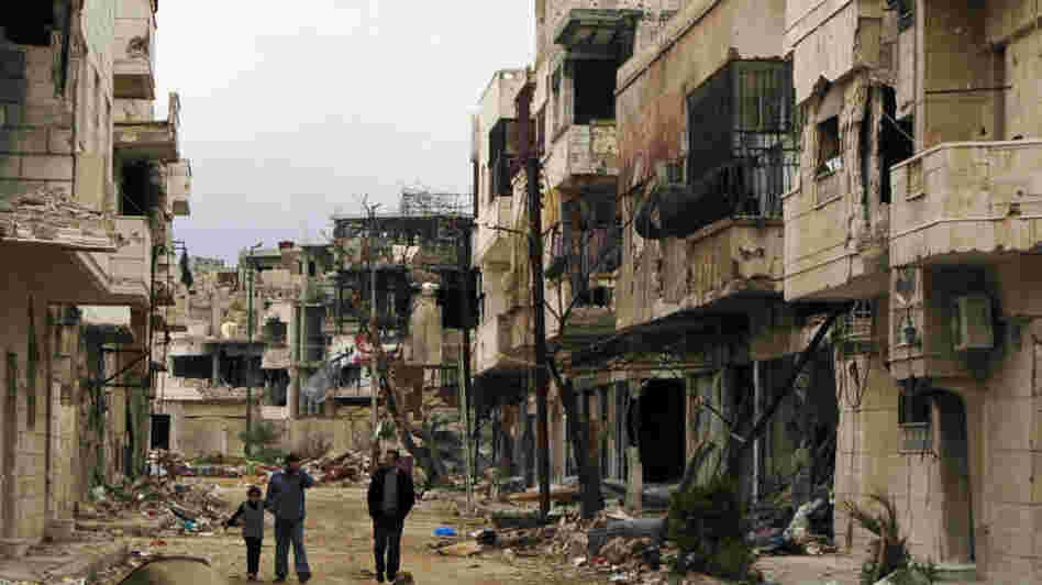 Syrians walk through a badly damaged neighborhood in the central city of Homs on Sunday. Despite a declared cease-fire, fighting has continued in a number of Syrian cities, and peace efforts are at risk of collapsing. Syrians walk through a badly damaged neighborhood in the central city of Homs on Sunday. Despite a declared cease-fire, fighting has continued in a number of Syrian cities, and peace efforts are at risk of collapsing.