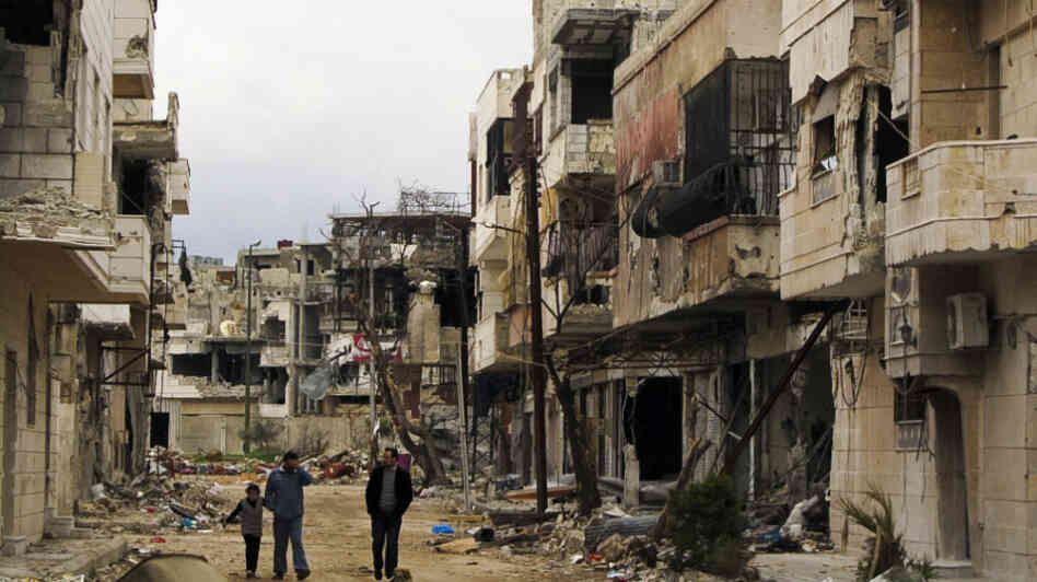 Syrians walk through a badly damaged neighborhood in the central city of Homs on Sunday. Despite a declared cease-fire, fighting has continued in a number of Syrian cities, and peace efforts are at risk of collapsing. Syrians walk through a badly damaged neighborhood in the central city of Homs on Sunday. Despite a declared cease-fire, fighting has continued in a number of Syrian cities, and peace efforts are at risk of collapsing.