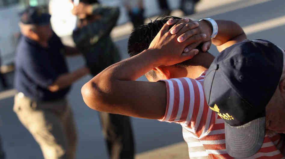 Undocumented immigrants are searched before boarding a deportation flight in Mesa, Ariz., last June. Since the passage of the state's immigration law two years ago, thousands of illegal workers have left.
