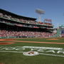 The flag covers the Green Monster as the national anthem is played before the game between the Boston Red Sox and the Tampa Bay Rays on April 16 at Fenway Park in Boston.