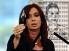 Argentine President Cristina Fernandez holds a petroleum sample as she announces plans for her government to nationalize a giant oil company that is largely owned by a private Spanish company, Repsol. Behind her is an image of the country's former first lady, Eva Peron. Argentine President Cristina Fernandez holds a petroleum sample as she announces plans for her government to nationalize a giant oil company that is largely owned by a private Spanish company, Repsol. Behind her is an image of the country's former first lady, Eva Peron.