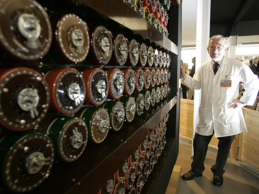 Mike Hillyard, a volunteer who helped build a replica of the Turing Bombe machine, stands beside the machine at Bletchley Park in Milton Keynes, England, in 2009.