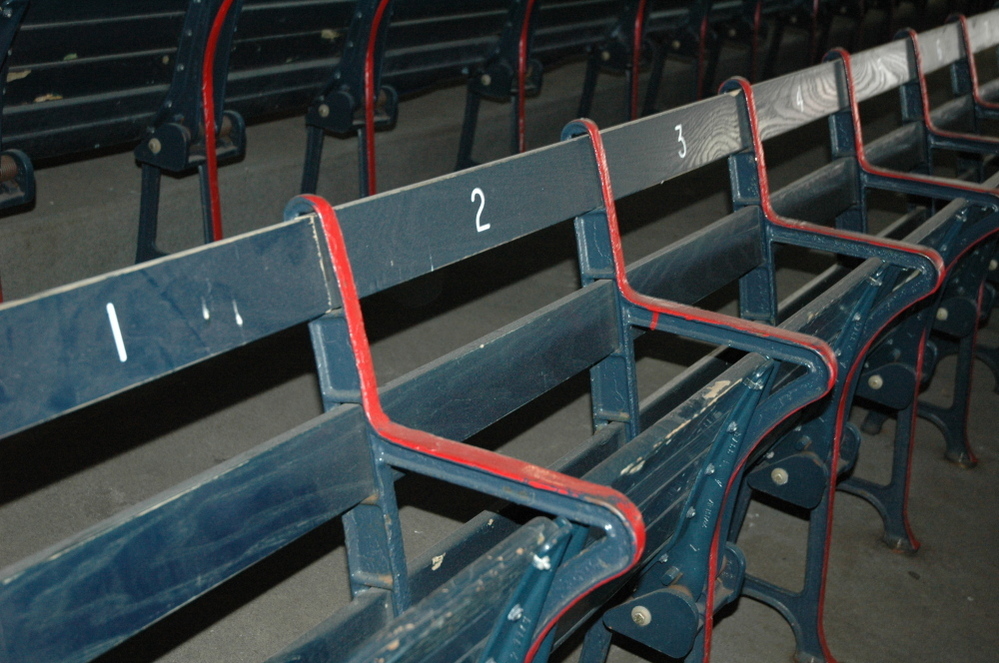 Fenways boasts "the oldest seats in baseball." Owners purposely decided not to sandblast the layers of paint, but rather to let these right field grandstand seats show their history and their age.