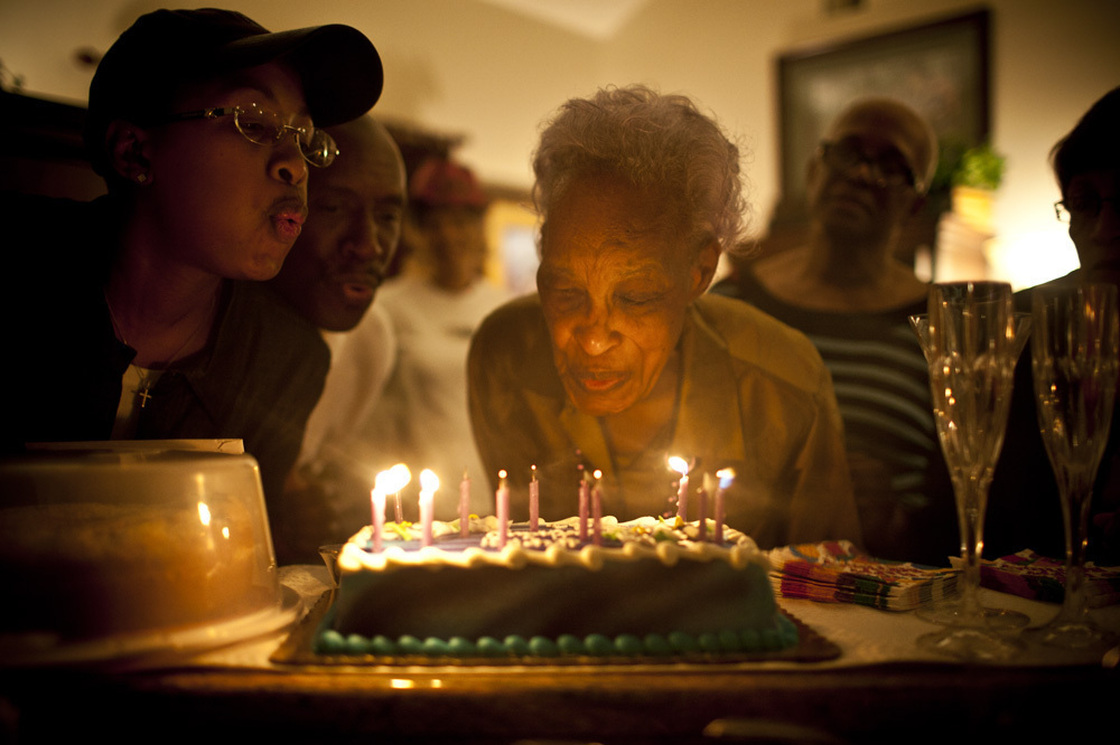 Ida Christian, 89, gets help from her granddaughter, Yolanda Hunter (left), in blowing out the candles on her birthday cake.