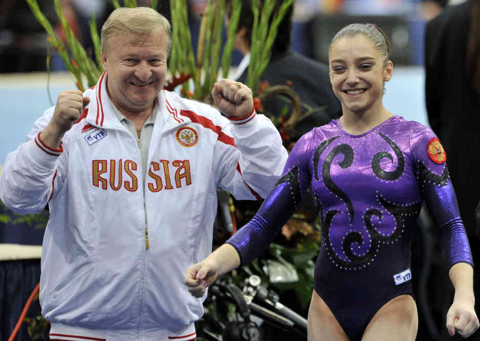 Aliya Mustafina celebrates with her coach, Alexander Alexandrov, after winning the gold medal in the women's individual all-around at the 2010 World Championships in the Netherlands. She suffered injuries that prevented her from competing in 2011. Aliya Mustafina celebrates with her coach, Alexander Alexandrov, after winning the gold medal in the women's individual all-around at the 2010 World Championships in the Netherlands. She suffered injuries that prevented her from competing in 2011.