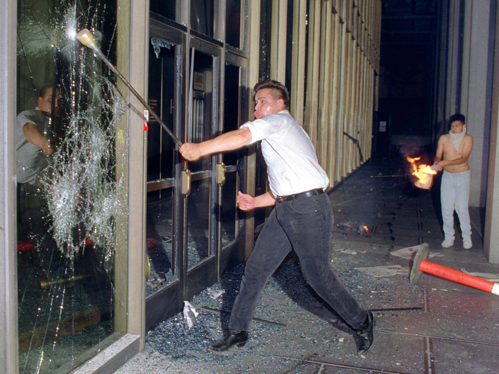 A rioter breaks glass at the Criminal Courts building in Los Angeles on April 29, 1992, after a jury acquitted four police officers accused of beating Rodney King.