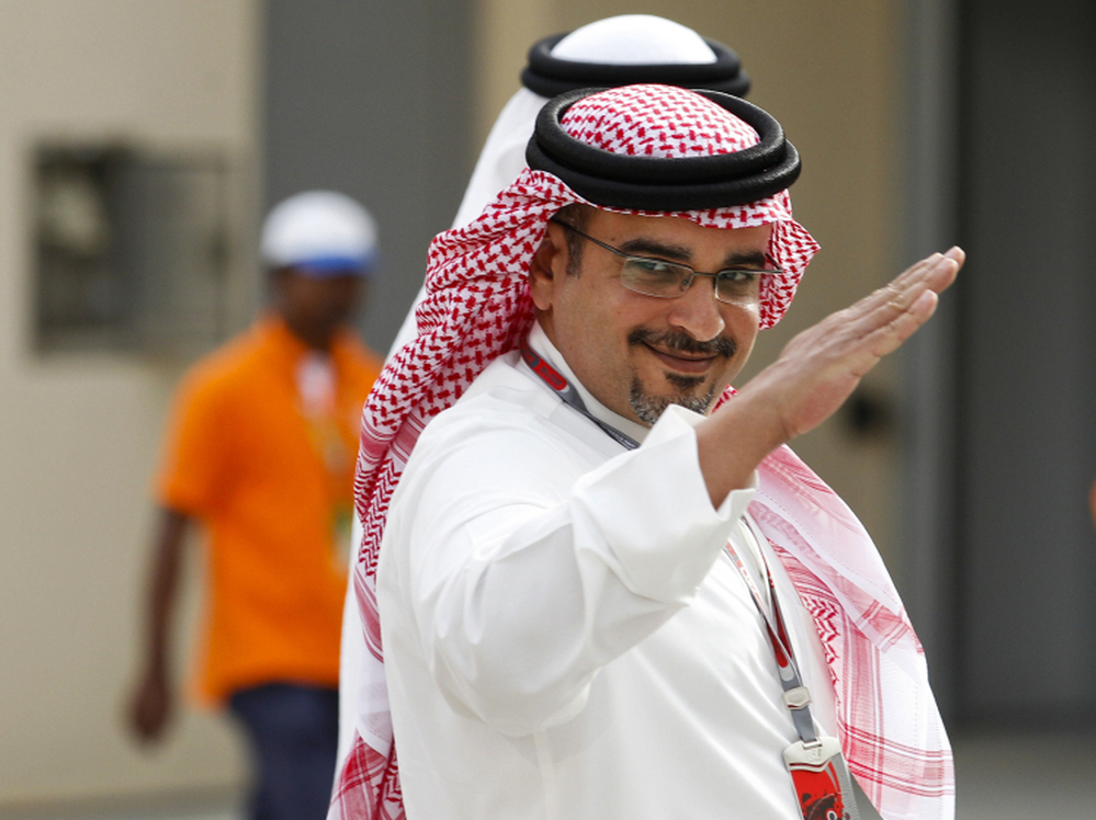 Bahraini Crown Prince Salman bin Isa Al Khalifa, shown here at a Formula One practice session Friday, says canceling the race would be giving in to "extremists."
