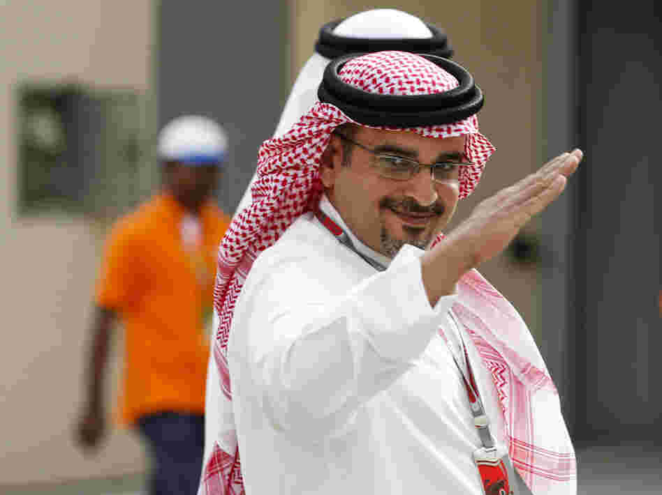 Bahraini Crown Prince Salman bin Isa Al Khalifa, shown here at a Formula One practice session Friday, says canceling the race would be giving in to "extremists."
