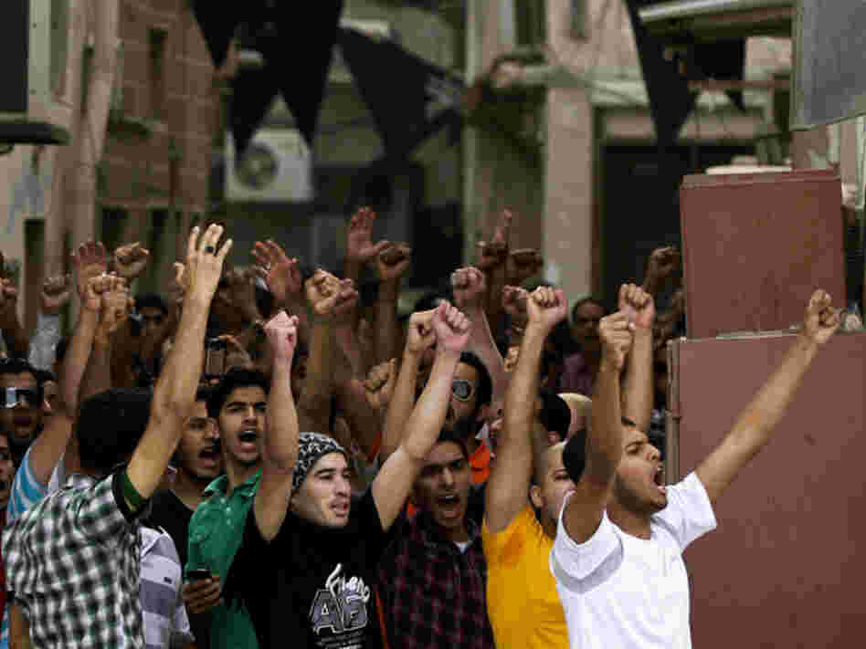 Anti-government protesters chant slogans in Manama, Bahrain, on Thursday. Security forces have fanned out to prevent demonstrators from disrupting Sunday's Formula One race.