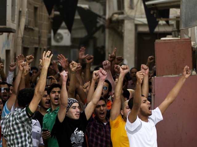 Anti-government protesters chant slogans in Manama, Bahrain, on Thursday. Security forces have fanned out to prevent demonstrators from disrupting Sunday's Formula One race.