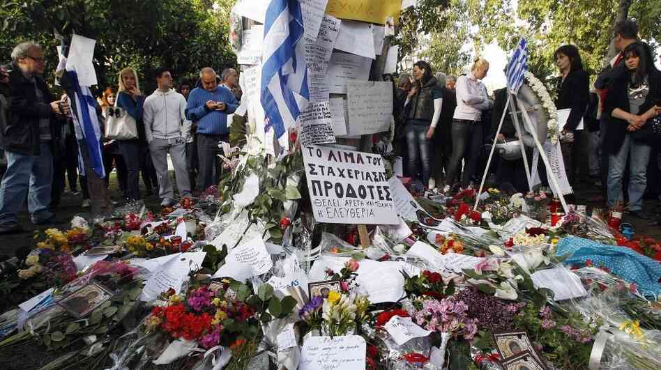 Mourners gather at the spot in front of the Greek parliament in Athens where 77-year-old retired pharmacist Dimitris Christoulas shot and killed himself on April 4. Christoulas left a note saying he did not want to end up scrounging for food in garbage bins.