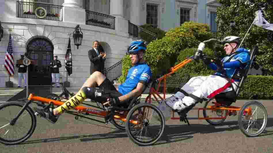 Brothers Deven (left) and Erik Schei ride by President Barack Obama on the South Lawn of the White House as part of the sixth annual Wounded Warrior Project's Soldier Ride on Friday. Brothers Deven (left) and Erik Schei ride by President Barack Obama on the South Lawn of the White House as part of the sixth annual Wounded Warrior Project's Soldier Ride on Friday.