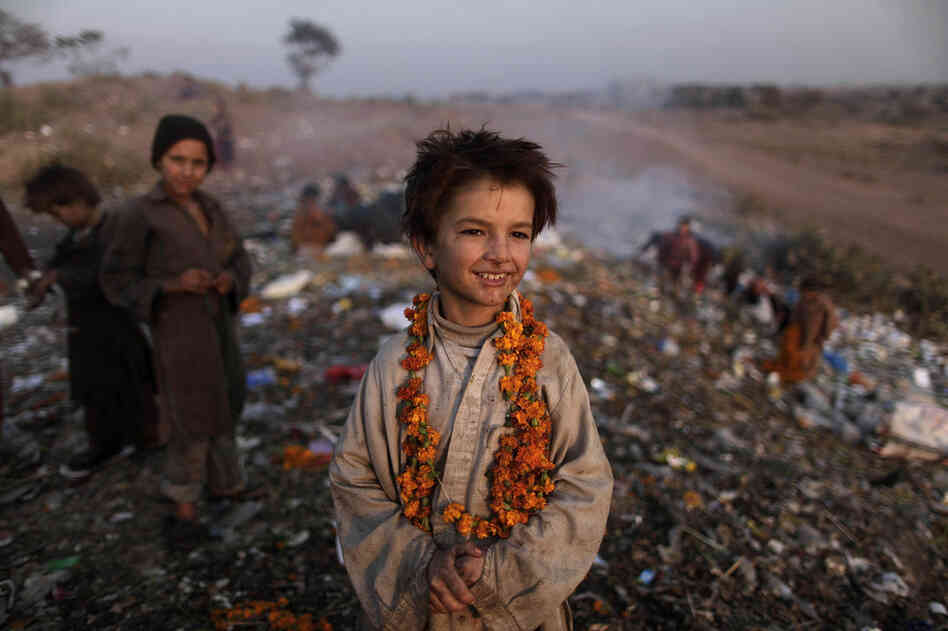 Afghan refugee Shafiq Mohammed, 9, and other children search through a dump on the outskirts of Islamabad, Pakistan. 