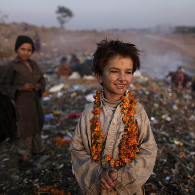 Afghan refugee Shafiq Mohammed, 9, and other children look for items of use on the outskirts of Islamabad, Pakistan, in December.