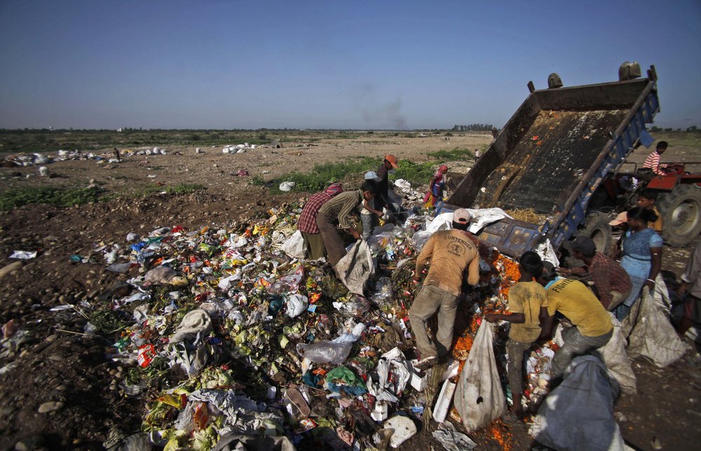 Ragpickers comb a garbage dump on the outskirts of Jammu, India. 