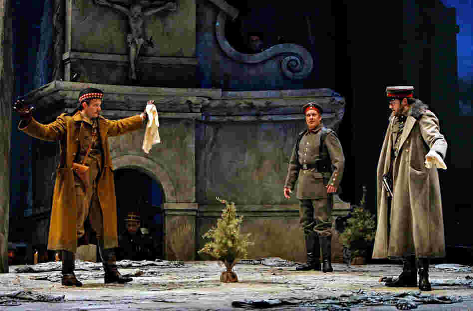 It's Christmas Eve on the battlefield. German opera singer Nikolaus Sprink (William Burden, center) wades into no man's land with a small Christmas tree, inspiring a sudden cease-fire. He's accompanied by Scotsman Lieutenant Gordon (Gabriel Preisser, left) and German Lieutenant Horstmayer (Craig Irvin).
