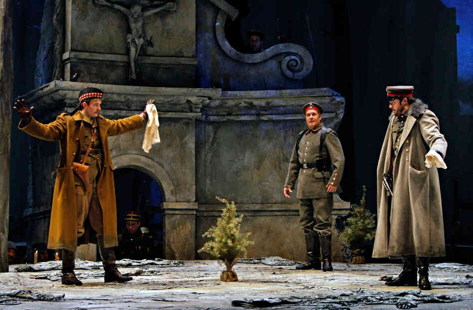 It's Christmas Eve on the battlefield. German opera singer Nikolaus Sprink (William Burden, center) wades into no man's land with a small Christmas tree, inspiring a sudden cease-fire. He's accompanied by Scotsman Lieutenant Gordon (Gabriel Preisser, left) and German Lieutenant Horstmayer (Craig Irvin).