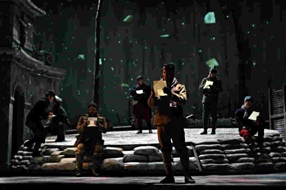 French, German and Scottish soldiers sing choruses in their native languages as they write home.