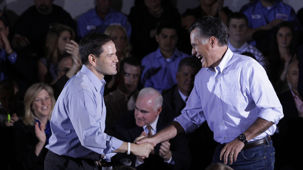 Republican presidential candidate Mitt Romney shakes hands with Sen. Marco Rubio, R-Fla., during a town hall-style meeting in Aston, Pa., on Monday.