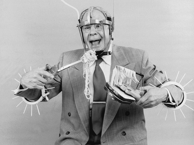 Russell E Oakes, an amateur American inventor wearing his problem solving inventions.