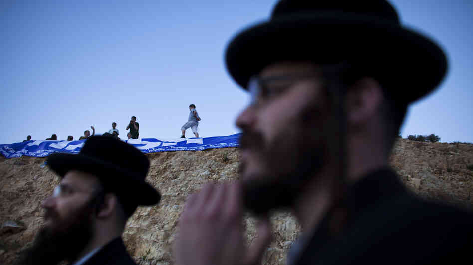 Israelis who support Jewish settlements in the West Bank rally against a demolition order for the outpost of Ulpana on Sunday. Israeli courts have ordered the outpost torn down, but Prime Minister Benjamin Netanyahu's government is looking to keep it intact.