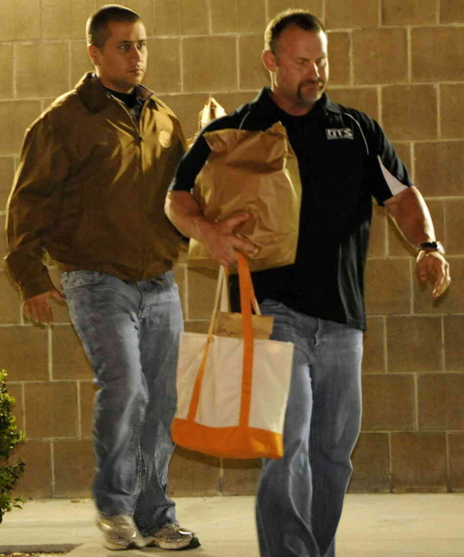 George Zimmerman, left, as he walked out of jail earlier today. The other man was not identified.