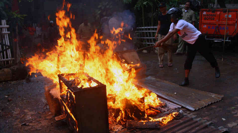 Local officials burn chicken coops in anticipation of a resurgence in bird flu in Jakarta, Indonesia, in January. Concerns about potential misuse of research into genes that control the contagiousness of flu have stymied publication. Local officials burn chicken coops in anticipation of a resurgence in bird flu in Jakarta, Indonesia, in January. Concerns about potential misuse of research into genes that control the contagiousness of flu have stymied publication.
