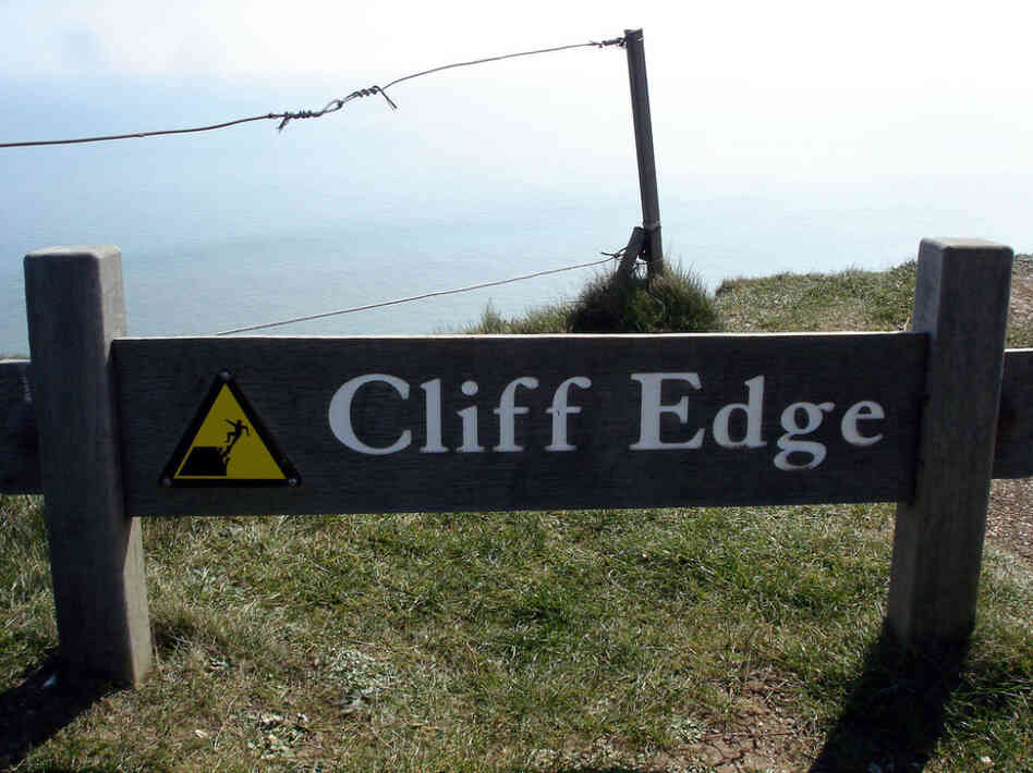 A sign marking the cliff edge. A sign marking the cliff edge.
