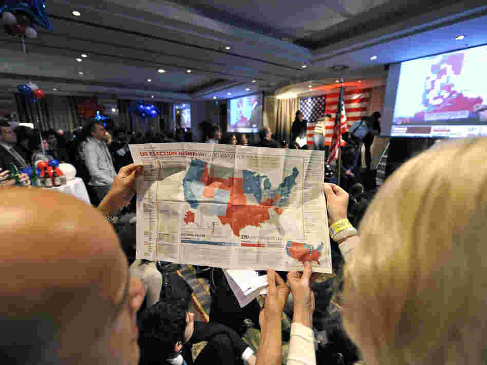 Onlookers study a map of the electoral college system during a Nov. 5, 2008, U.S. presidential election party in Brussels. This year, the electoral vote landscape could be more challenging for Mitt Romney than national popular vote polls might suggest.